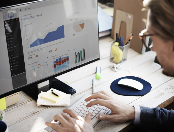 Man working on computer on Database Management & Analytics