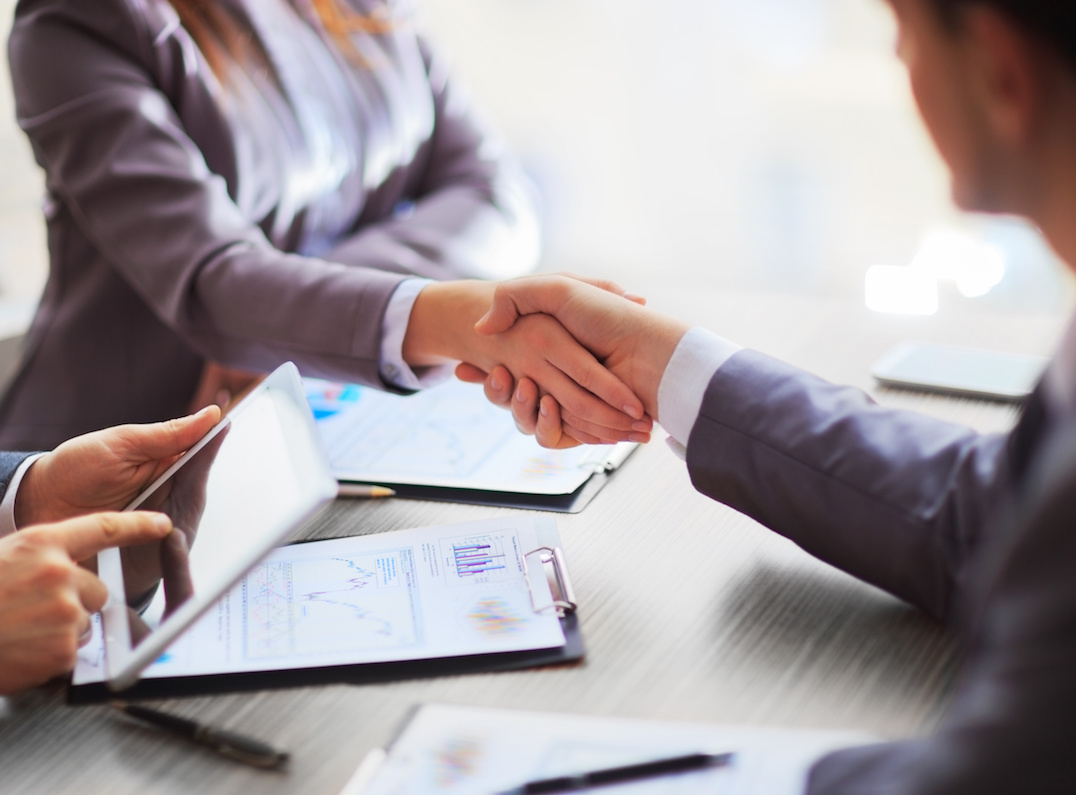 Progressive Data Services' team members shaking hands
