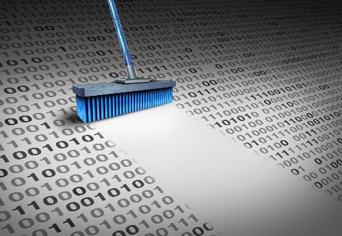 A broom sweeps a clear path through a sheet of ones and zeros - a representation of data cleaning.