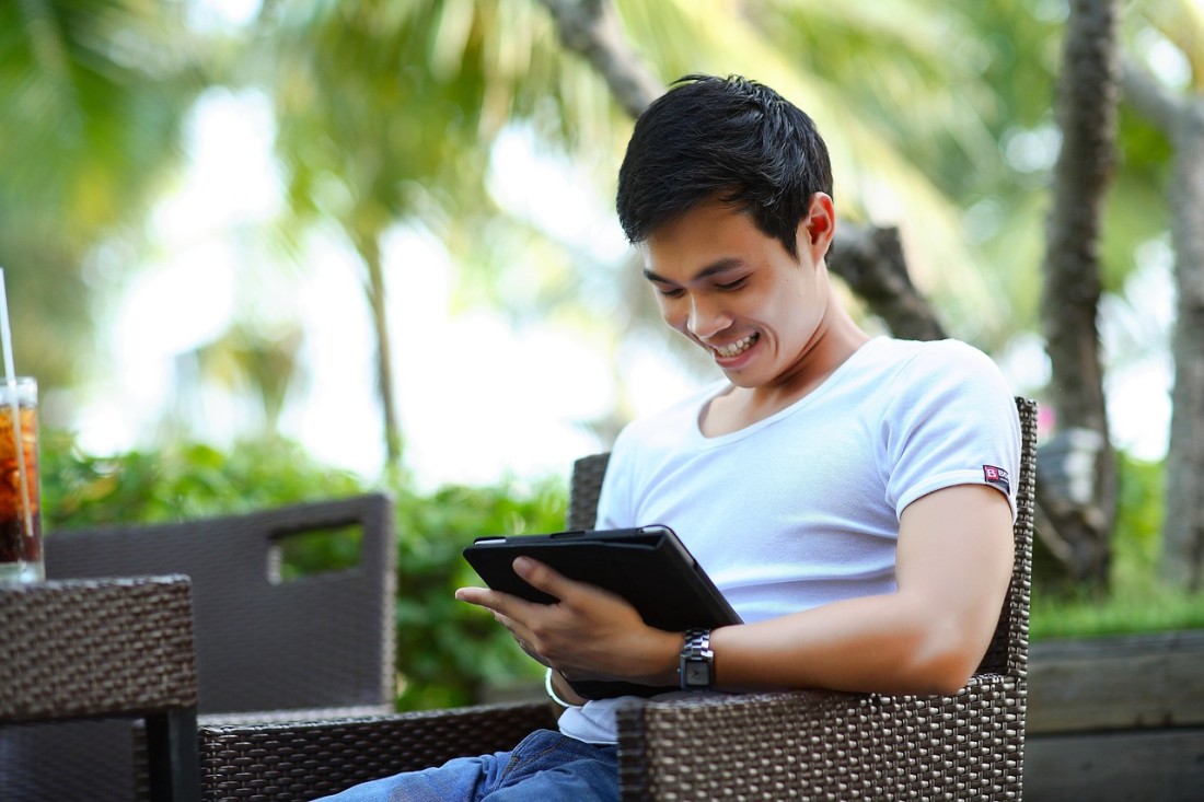 man using web app application on a tablet